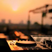 DJ decks set up against a sunset sky