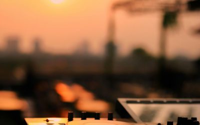 DJ decks set up against a sunset sky