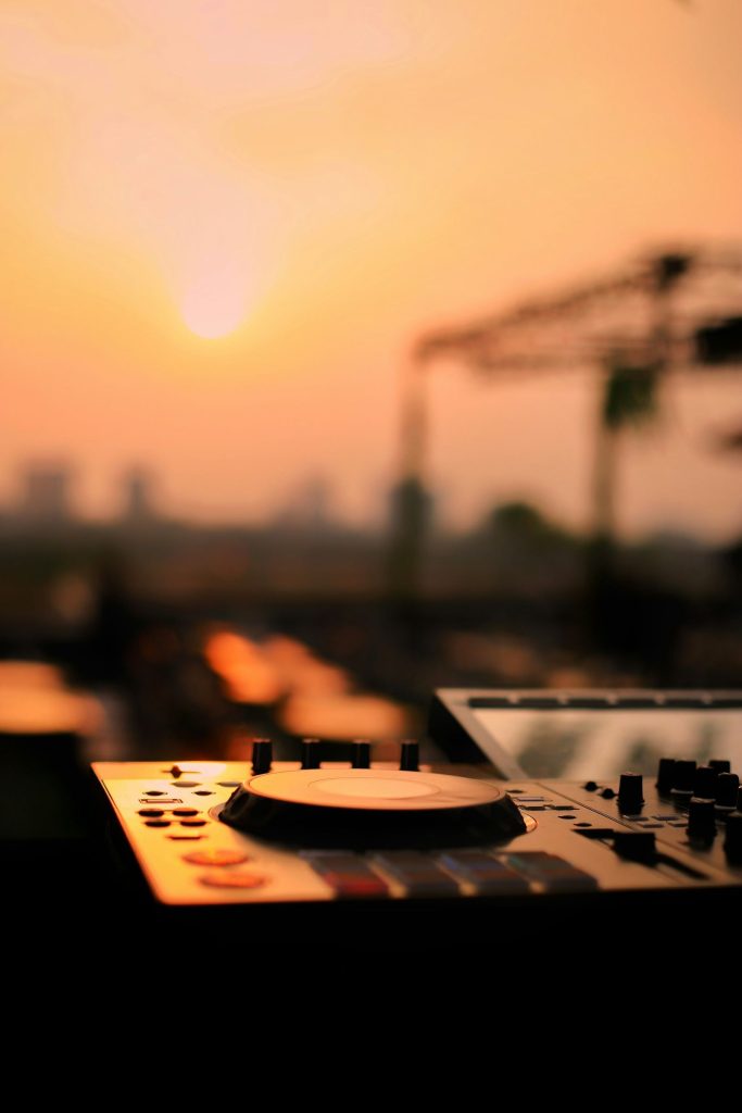 DJ decks set up against a sunset sky