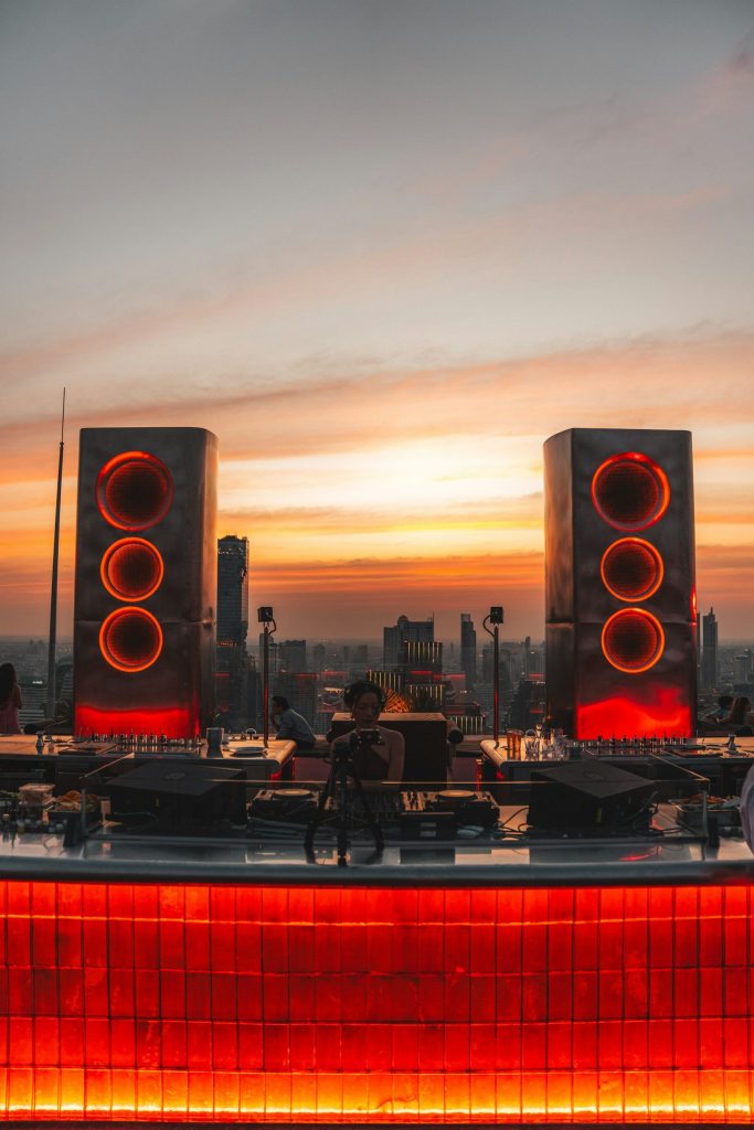 DJ booth with speakers at sunset