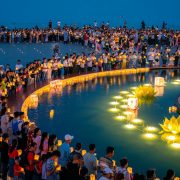 Crowds floating krathongs on the water at Loy Krathong