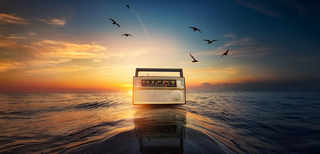 Vintage radio on the sea at sunset